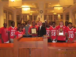 Photo of Council Member Carter with the Sweetwater Athletic Association Pop Warner football team members as they receive a resolution from the City Council, in the City Council Chambers, for winning the Midget Division National Championship.