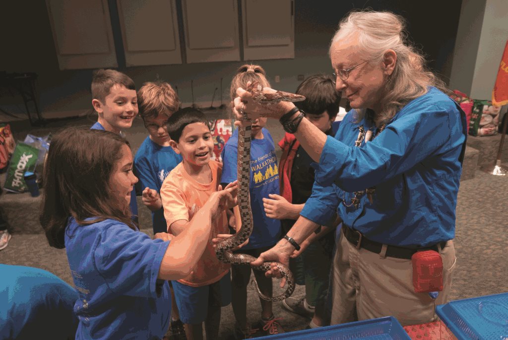 Park Naturalist shows a snake to school children