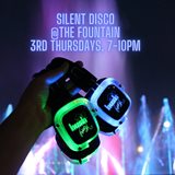 headphones with neon lights in front of the friendship fountain