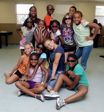 group of children posing wearing sunglasses