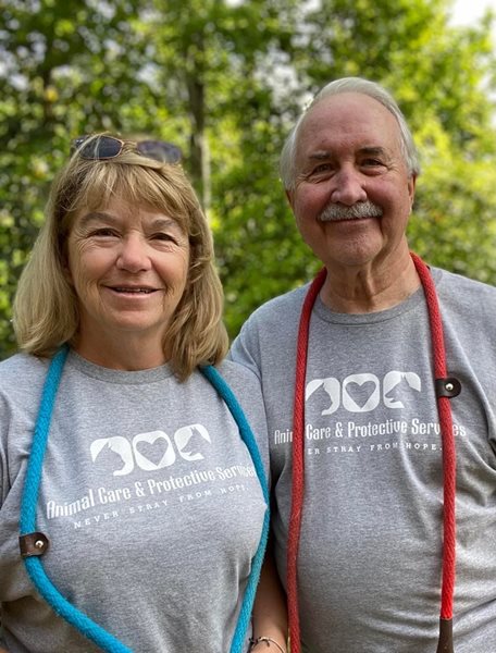 Karen and Darrell, volunteers wearing gray volunteer shirts. 