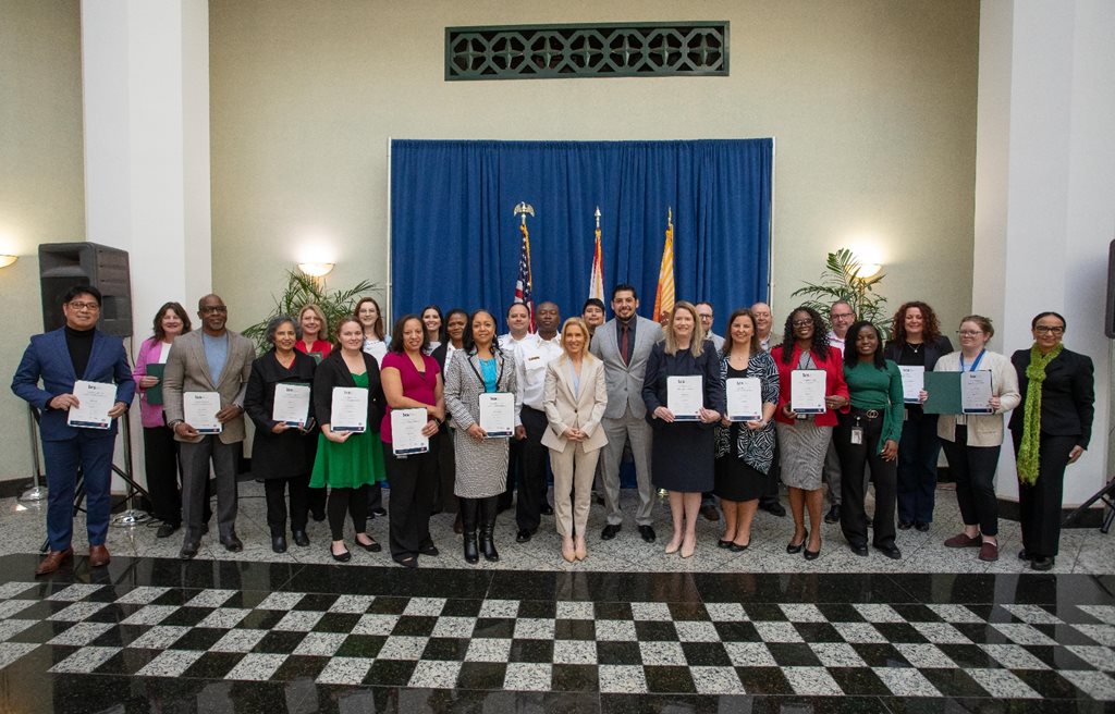 Award winners standing with Mayor in City Hall atrium