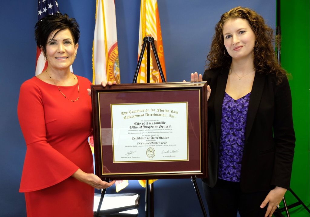 COJ OIG employees holding up accreditation certificate