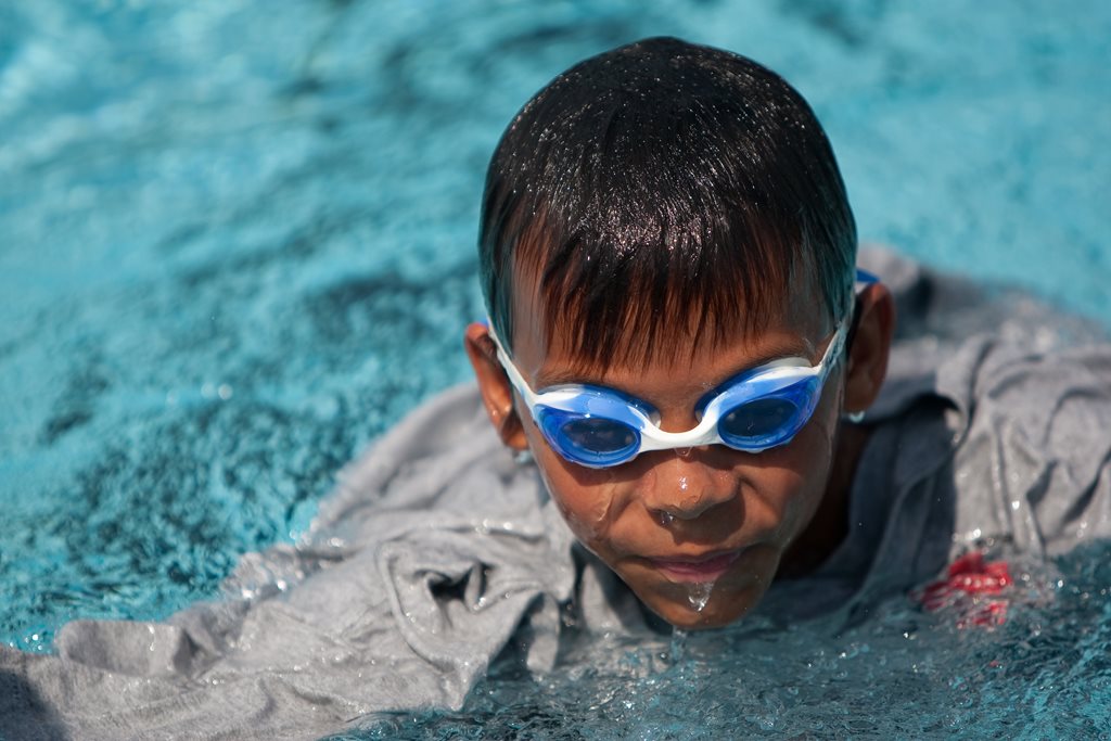 child swimming in pool