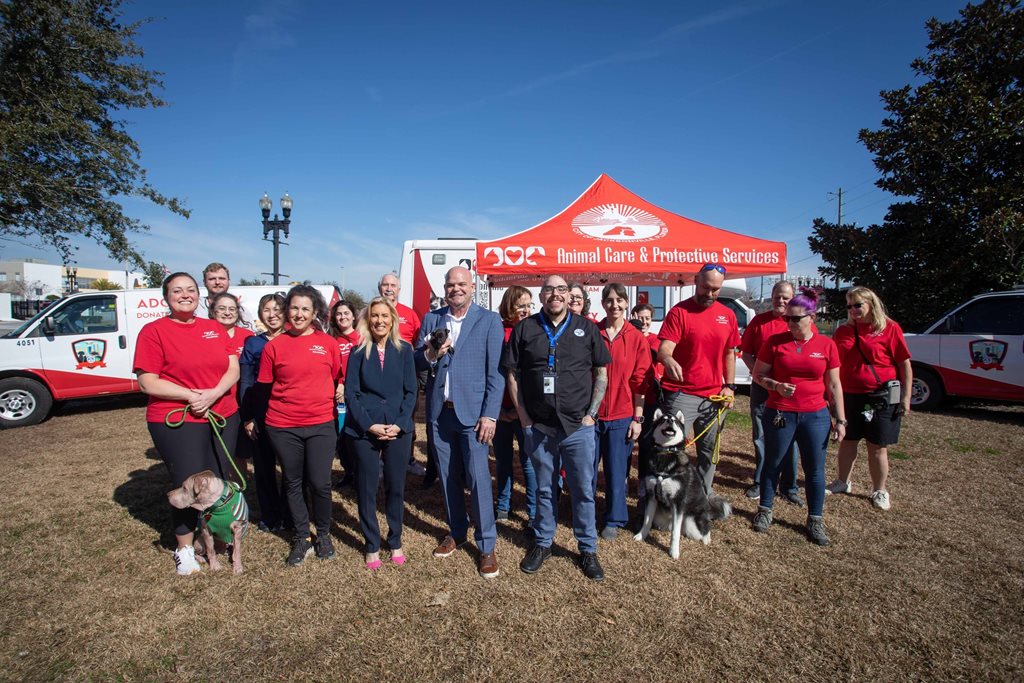 Mayor and group of people posing in front of ACPS tent