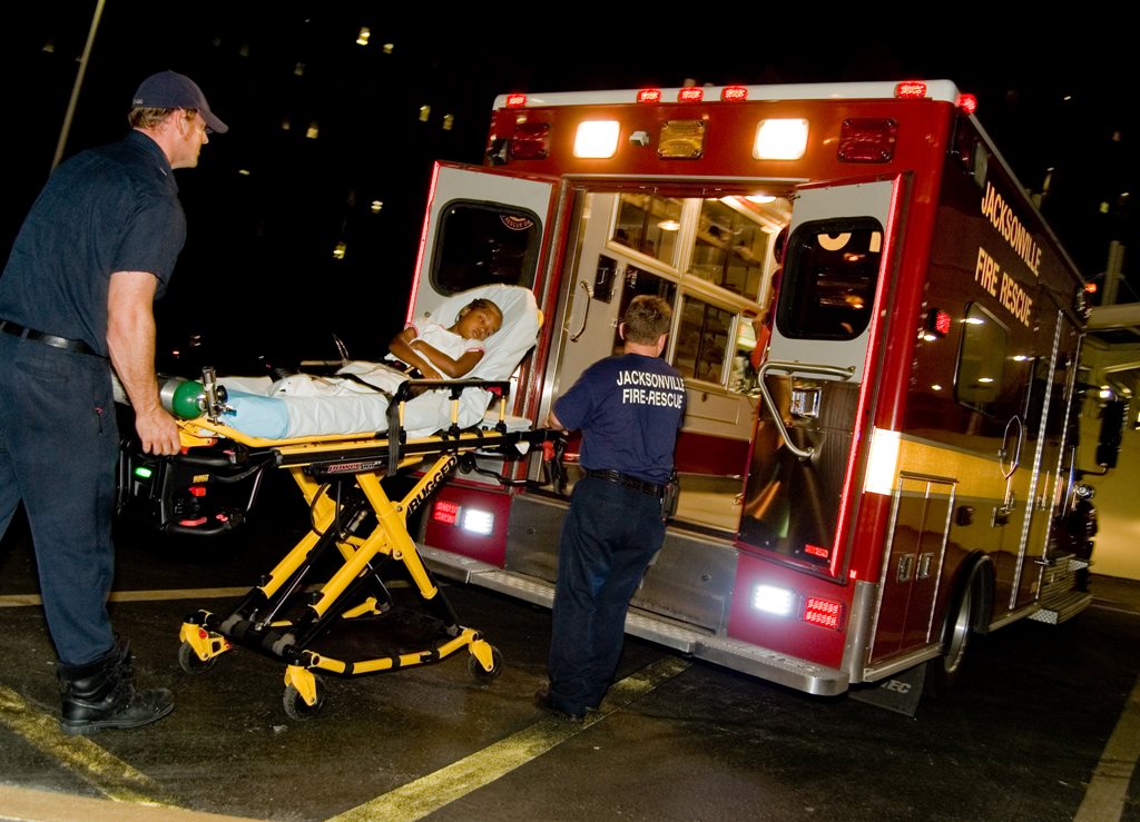 Firefighters placing a patient in a rescue unit