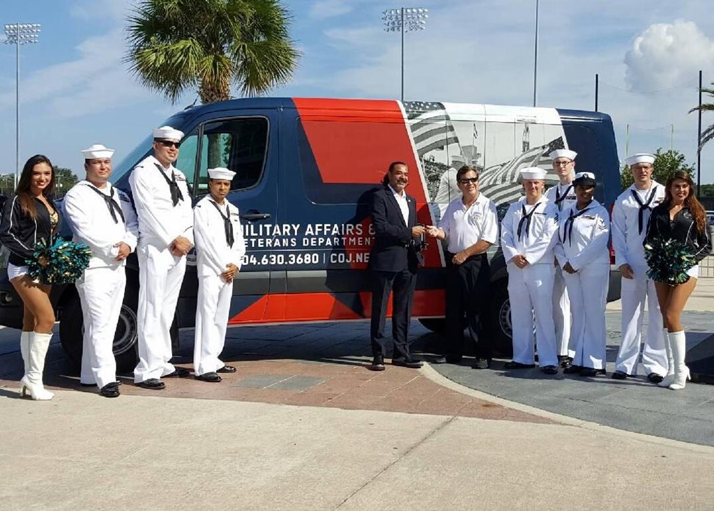 Jaguars owner Shad Khan handing the keys to Military affairs & Veterans Services Director Bill Spann.