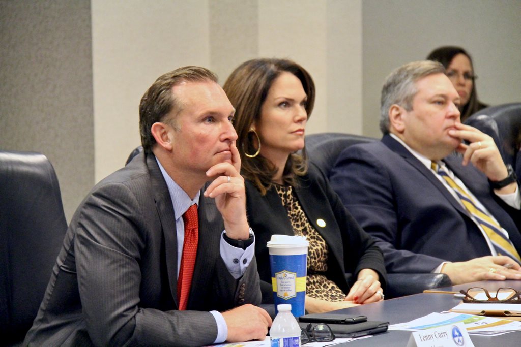 Mayoor Lenny Curry sits at a conference table listening to the Cure Violence Presentation