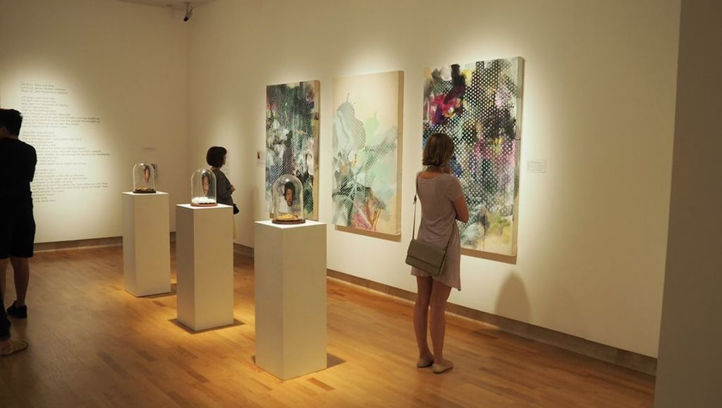 Woman looking at painting in an art gallery