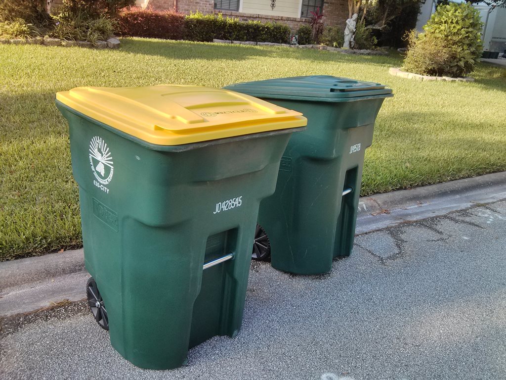 garbage and recycling cart on street curb