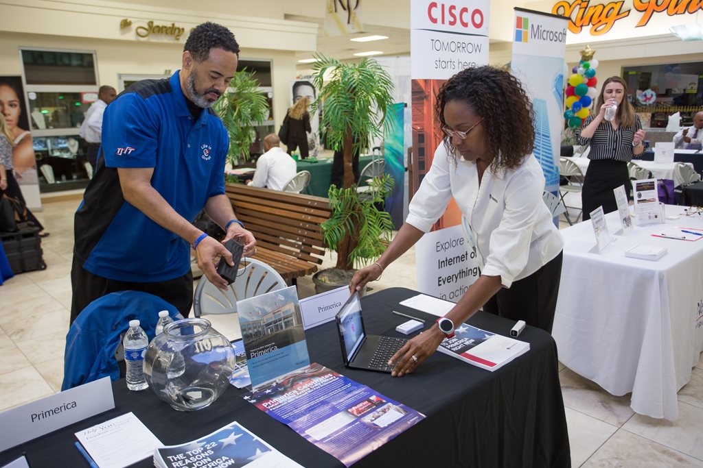 people setting up a booth at the veteran job fair