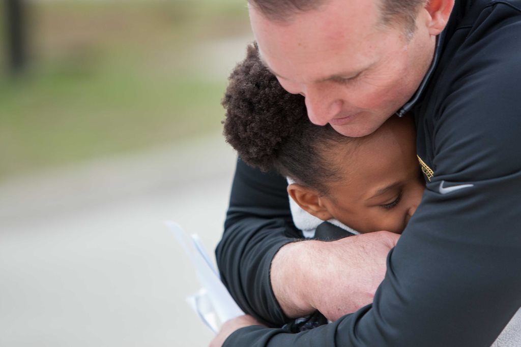 mayor lenny curry hugs young child