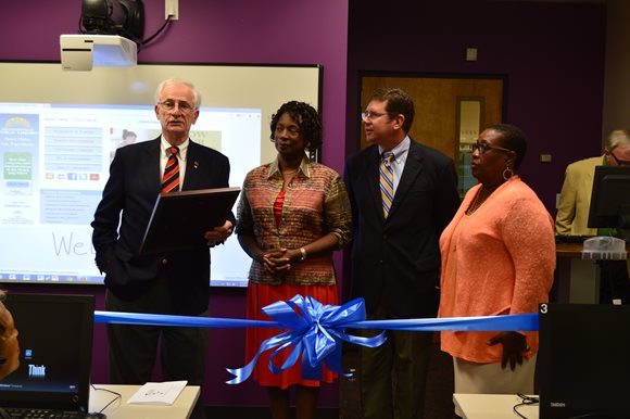 Photo of Council Member Bill Gulliford, Library Chair Brenda Simmons-Hutchins, Councilman Anderson and Councilwoman Lee at the ribbon cutting ceremony for the e-Classroom at the Bradham Brooks Branch Library.