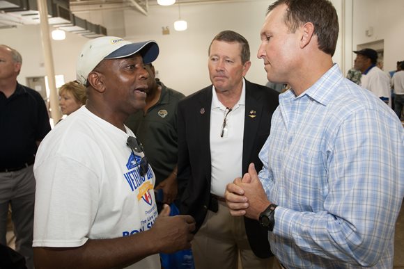 August 15, 2015 photo of Council Member Jim Love with Mayor Curry and a participant at the Homeless Veterans Stand Down.