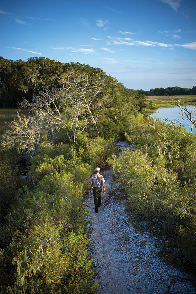 National Park Service Urban Fellow Nathan Souder walking along a trail in the Timucuan Ecological & Historic Preserve