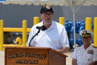 Photo of Council Member Jim Love speaking to the audience at the welcoming ceremony for the USS Iwo Jima and the USS Fort McHenry at Naval Station Mayport.
