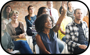 woman raising her hand at community meeting