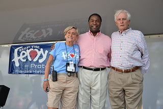 Photo of Council Vice President Bill Gulliford with St. Johns River Ferry Commissioner Elaine Brown and Mayor Alvin Brown on the stage.