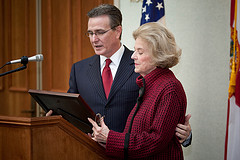 Photo of Council President Fussell presenting a comemorative resolution to Mrs. Alice Davis in front of the newly dedicated