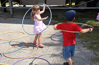 Photo of children playing with hoola hoops at the Ferry Fest.
