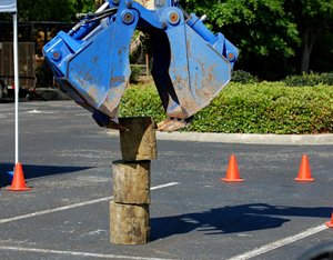 One of the competitions including using heavy equipment to stack sections of telephone posts