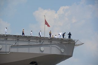 Photo of sailors on the USS Iwo Jima as it docks at Naval Station Mayport.
