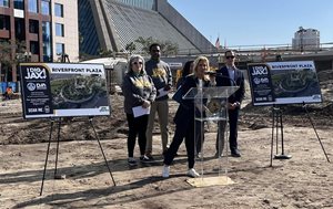 Mayor and other city officials at construction site behind podium