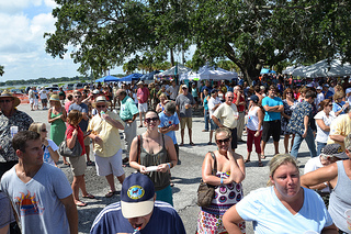Photo of the crowd of festival attendees enjoying the beautiful weather and fun activities at the Ferry Fest.